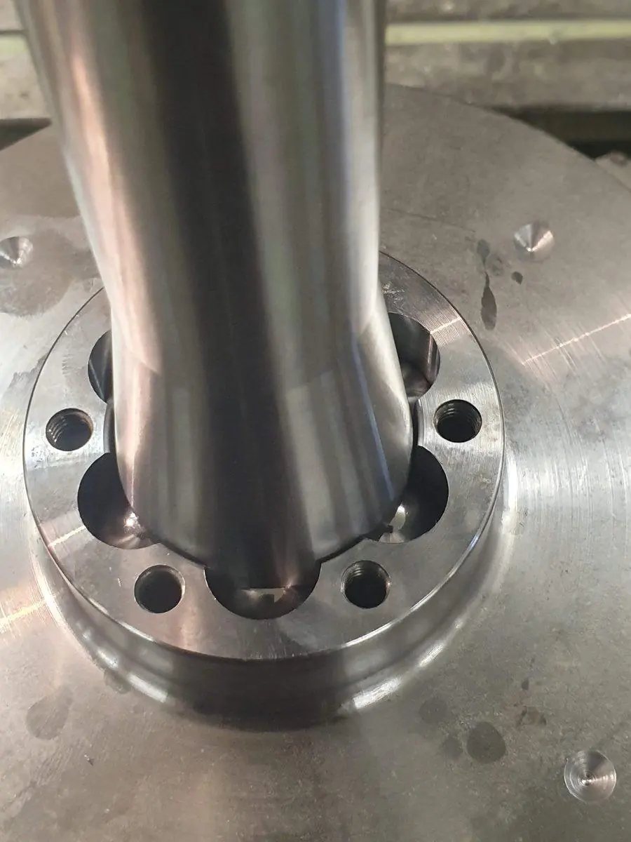 A polished stainless tube welded to a machined flange