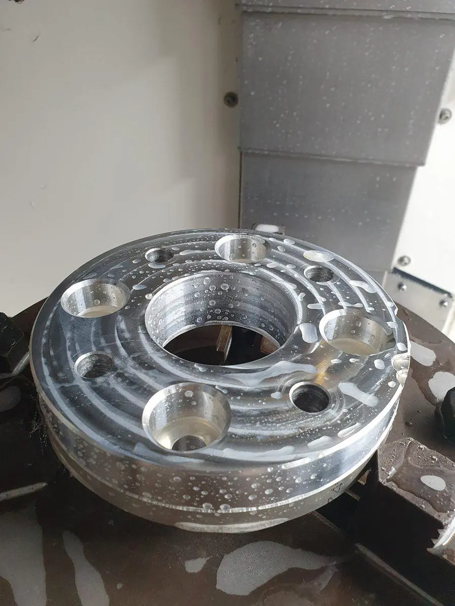 A machined aluminium hub with bored and counterbored features