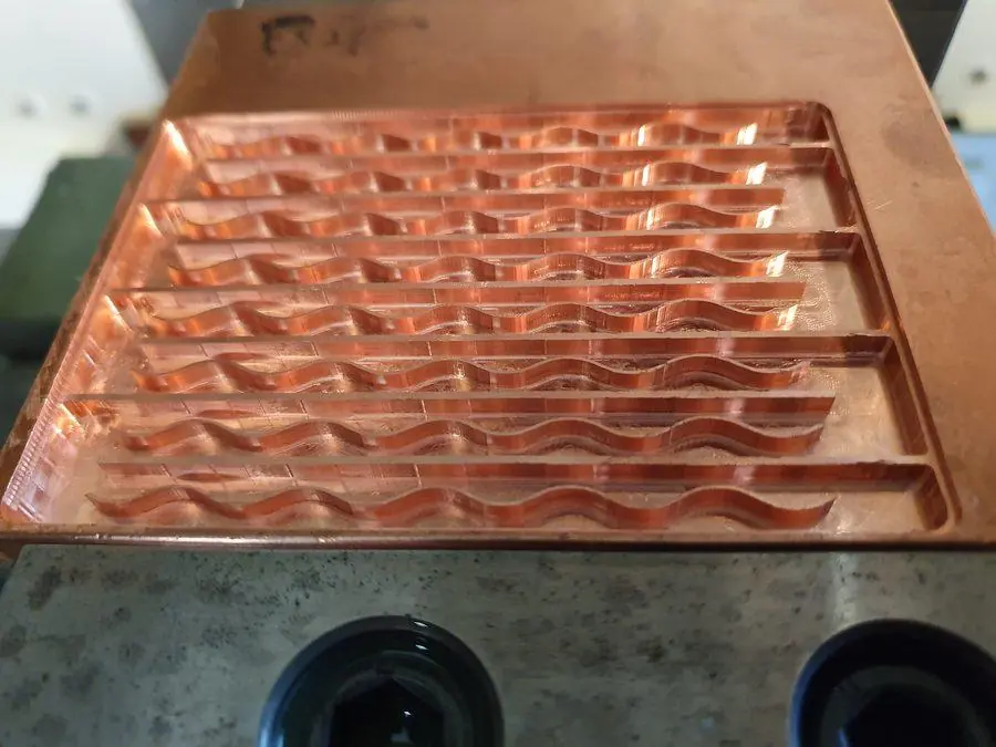 A copper plate machined with rows of formed pockets