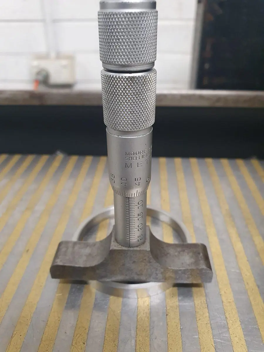 A height gauge set up on the surface plate for checking a part