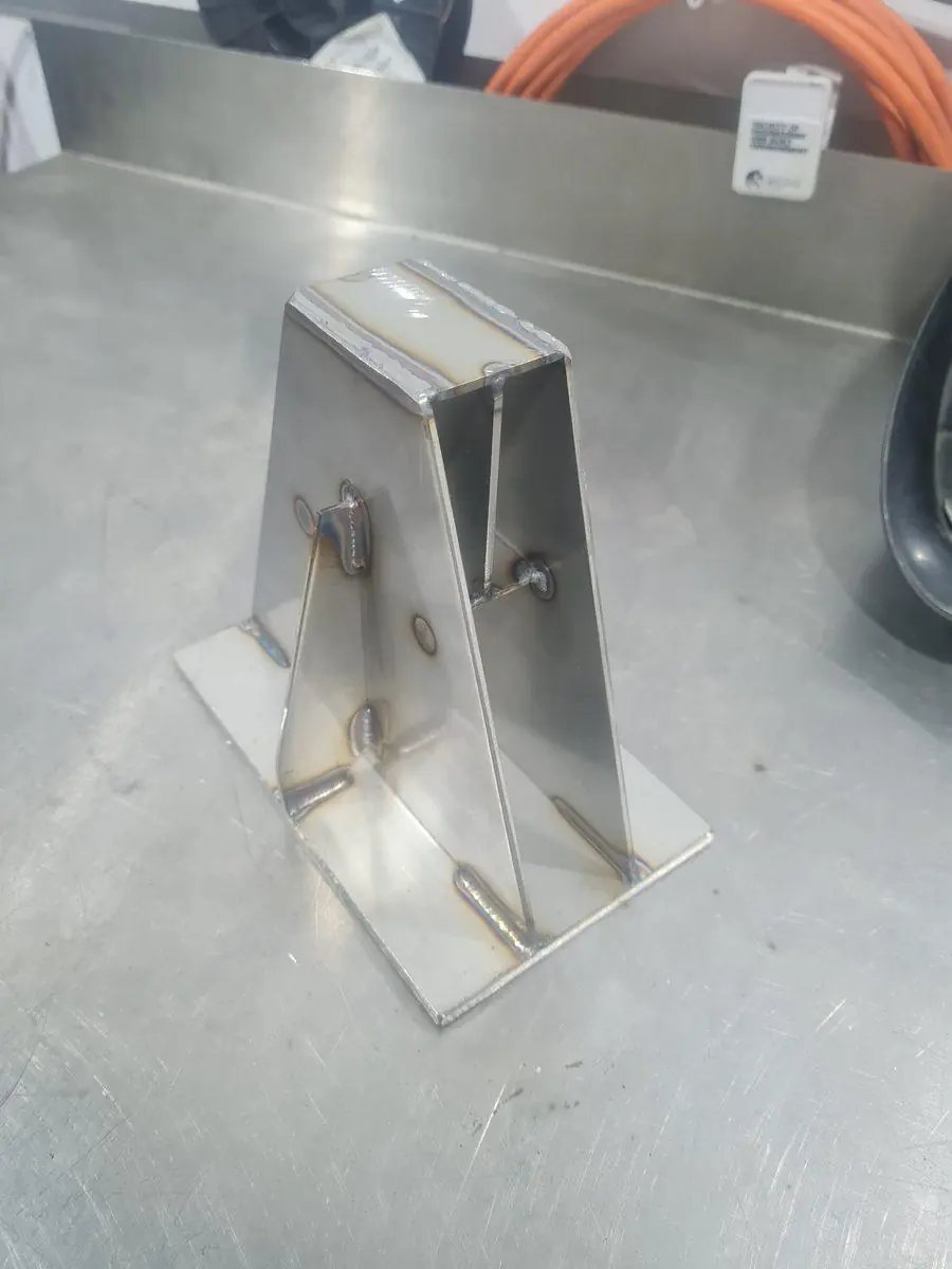 A folded stainless bracket with clean, sharp fold lines