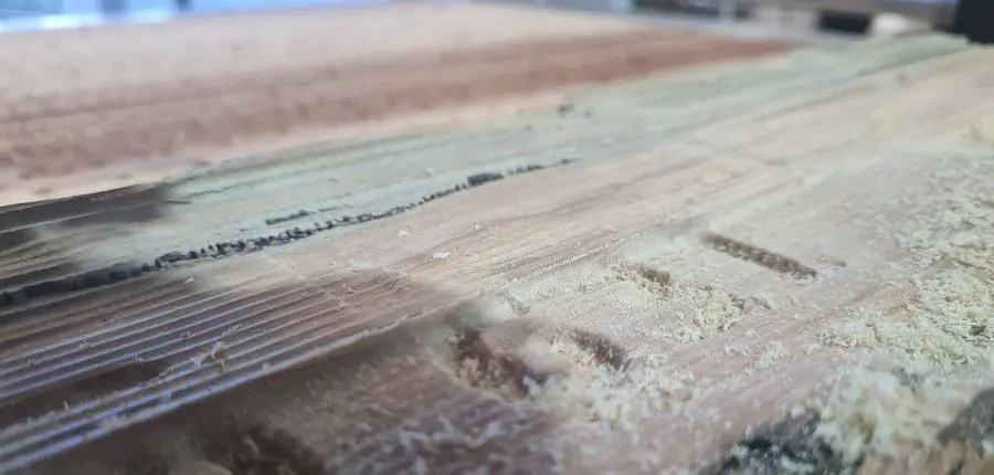 Close on carved detail and the surrounding machined texture