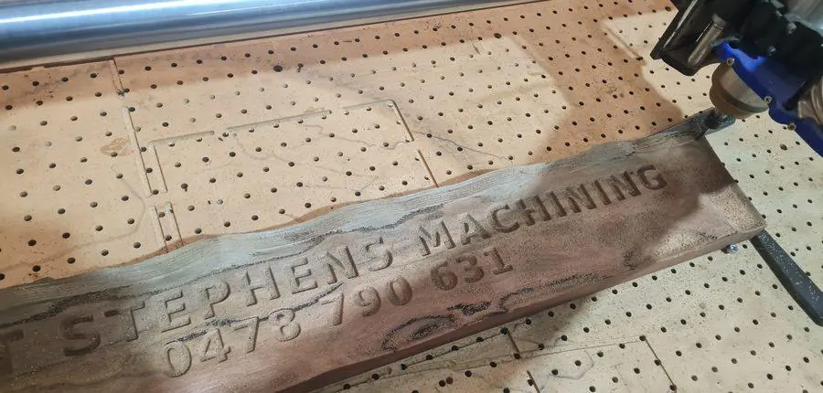 Carved lettering in a live-edge hardwood sign