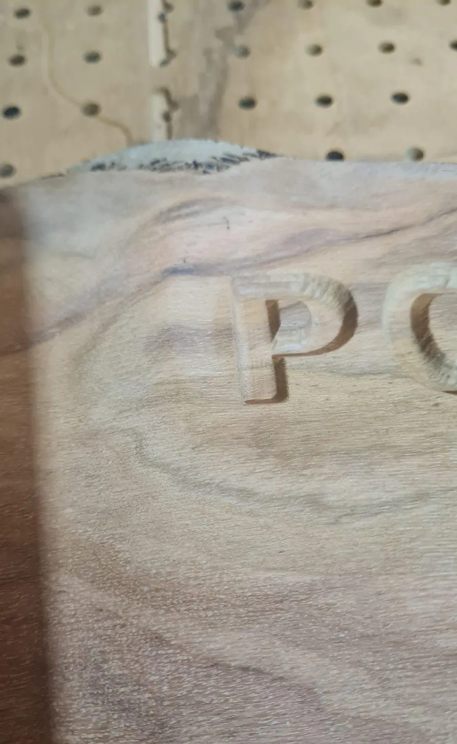 Close on a carved letter edge in hardwood